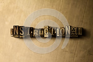 INSTRUCTIONAL - close-up of grungy vintage typeset word on metal backdrop photo