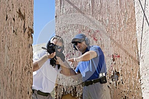 Instructor Assisting Man With Machine Gun