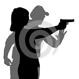 Instructor assisting woman aiming hand gun at firing range