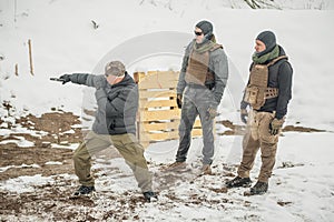 Instructor demonstrate action combat tactical gun shooting to his students