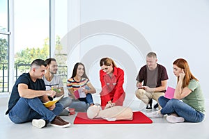 Instructor demonstrating CPR on mannequin