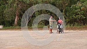 instructor explains best way of scooter balance to girl in helmet