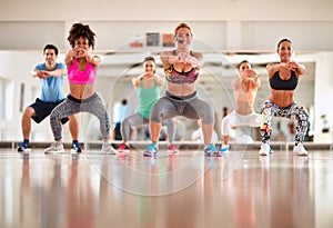 Instructor with group doing exercises for shaping body