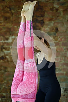 Instructor helps to do yoga exercise on an stretching