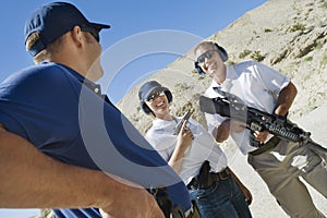 Instructor with man and woman at firing range