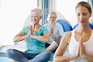 Instructor performing yoga with seniors