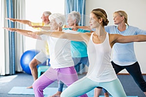 Instructor performing yoga with seniors