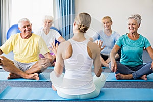 Instructor performing yoga with seniors