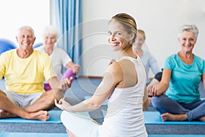 Instructor performing yoga with seniors