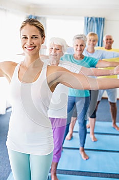 Instructor performing yoga with seniors