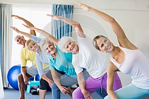 Instructor performing yoga with seniors