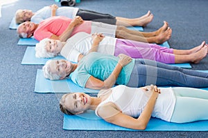 Instructor performing yoga with seniors