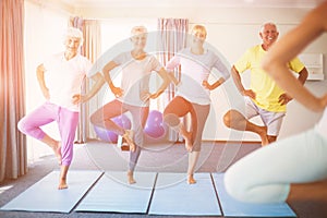 Instructor performing yoga with seniors