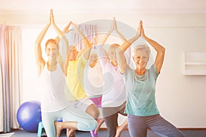 Instructor performing yoga with seniors