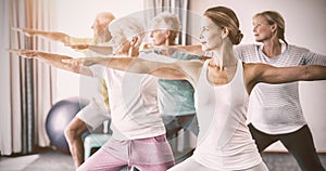 Instructor performing yoga with seniors