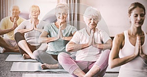 Instructor performing yoga with seniors