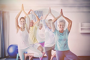 Instructor performing yoga with seniors