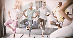 Instructor performing yoga with seniors