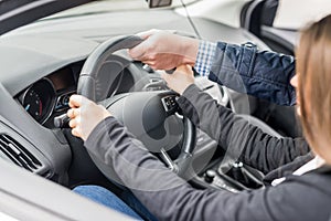 Instructor`s hand helping drive to a woman