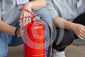 Instructor showing how to use a fire extinguisher on a training