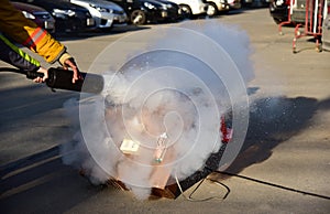 Instructor showing how to use a fire extinguisher on a training