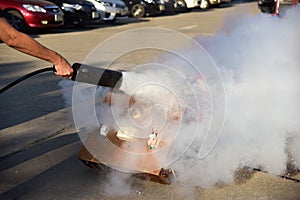 Instructor showing how to use a fire extinguisher on a training
