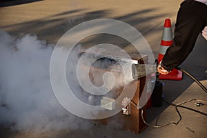 Instructor showing how to use a fire extinguisher on a training