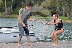 instructor showing woman how to waterski