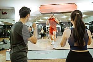 instructor on stage doing the hold stance during group exercises