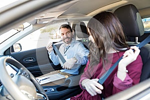 Instructor And Student Fastening Car Seatbelts