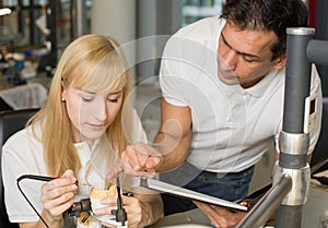 Instructor teaching an apprentice in dental lab