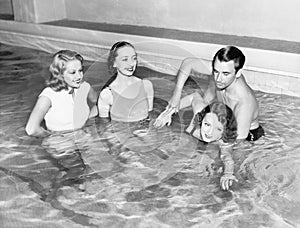 Instructor teaching women how to swim