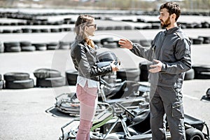 Instructor with woman on the track with go-karts