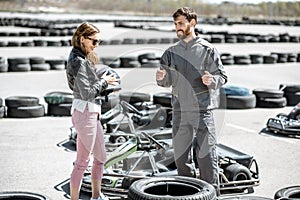 Instructor with woman on the track with go-karts photo