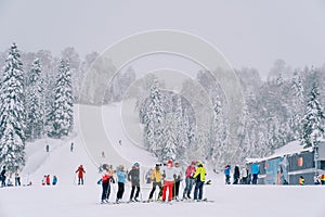 Instructors brief a group of skiers before climbing the mountain