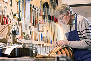 Instrument maker carving the body of a lute