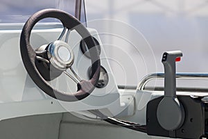 Instrument panel and steering wheel of a motor boat cockpit yacht control bridge.