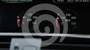 Instrument panel with tachometer, Close up image of illuminated car dashboard. Red arrow moving