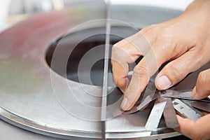 Instrument technician measuring flatness of orifice plate by using filler gauge for inspect the condition of measurement element