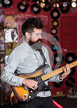 Instrumentalist concept. Musician with beard play electric guitar