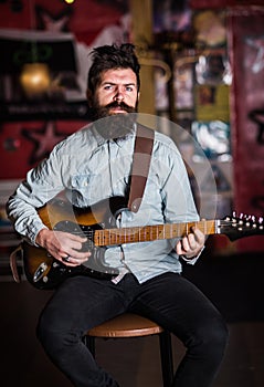 Instrumentalist concept. Musician with beard play electric guitar musical instrument.