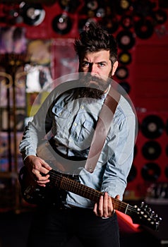 Instrumentalist concept. Musician with beard play electric guitar musical instrument.