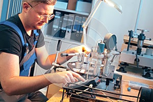 Instrumentation fitter performs equipment diagnostics and calibration at his desk