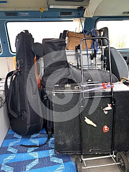 The instruments in the cases are loaded into the van.