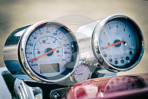 Instruments: speedometer, tachometer and clock on the steering wheel of a motorcycle