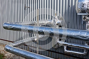 View of the insulated glycol pipelines near to the manufacturing building photo