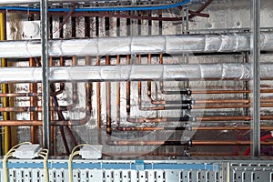 Insulates hot water pipes and copper pipes hang from the subceiling