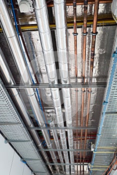 Insulates hot water pipes and copper pipes hang from the subceiling