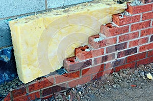 Insulating walls of new build houses by placing rock wool inside wall cavities as part of the energy-saving measures close-up.
