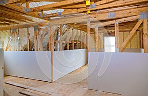 Inside attic roof andwall insulation in wooden house, building under construction